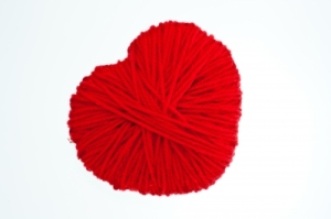 Heart wrapped in red yarn.